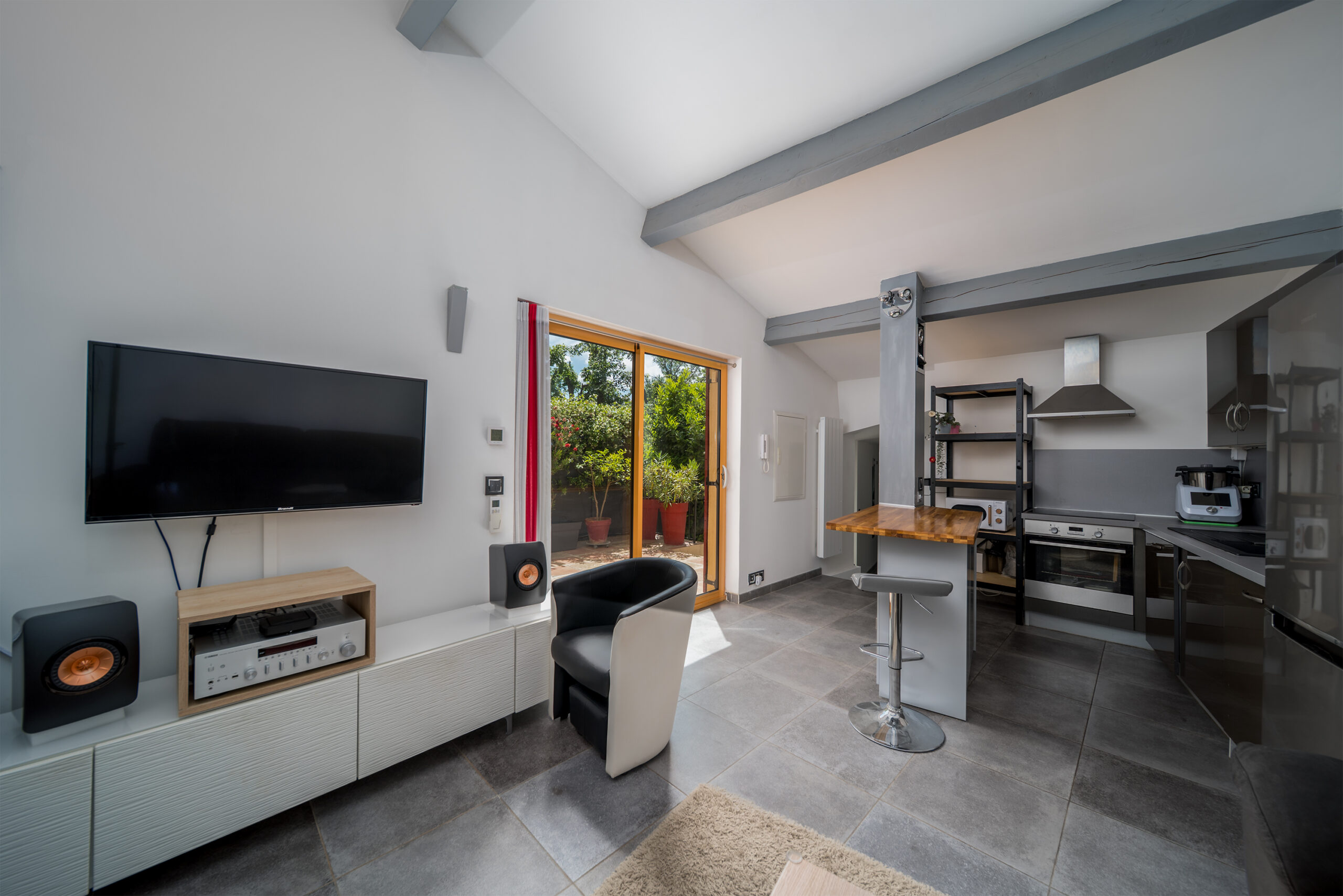 A large and comfortable lounge with adjacent kitchen.