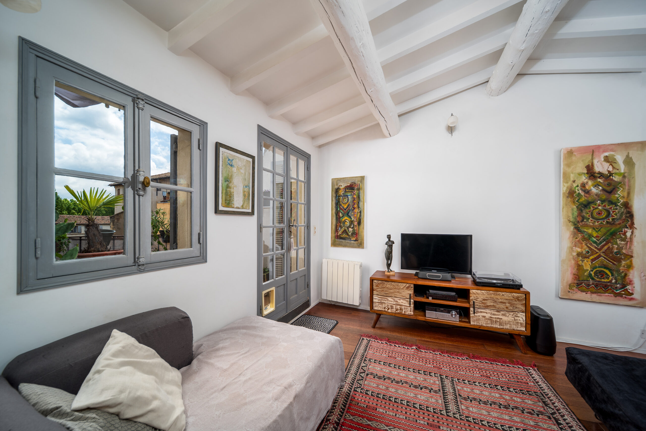 a living room with a couch and a rug