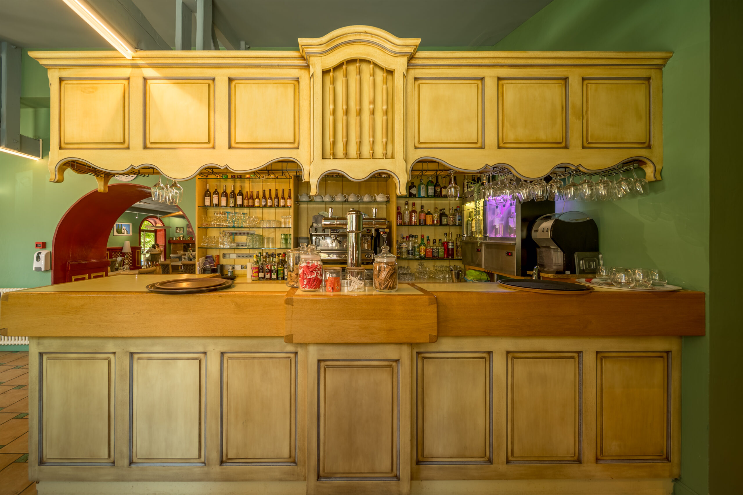 a bar with glasses and bottles